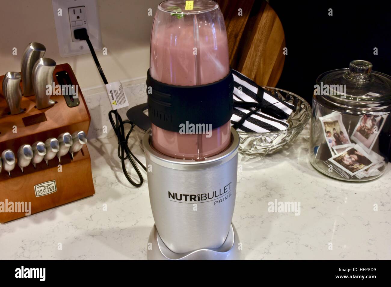 https://c8.alamy.com/comp/HHYED9/making-a-smoothie-with-the-nutribullet-blender-in-a-modern-kitchen-HHYED9.jpg