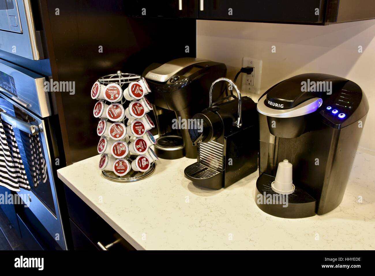 https://c8.alamy.com/comp/HHYEDE/a-modern-kitchen-with-two-keurig-coffee-machines-and-a-nespresso-machine-HHYEDE.jpg