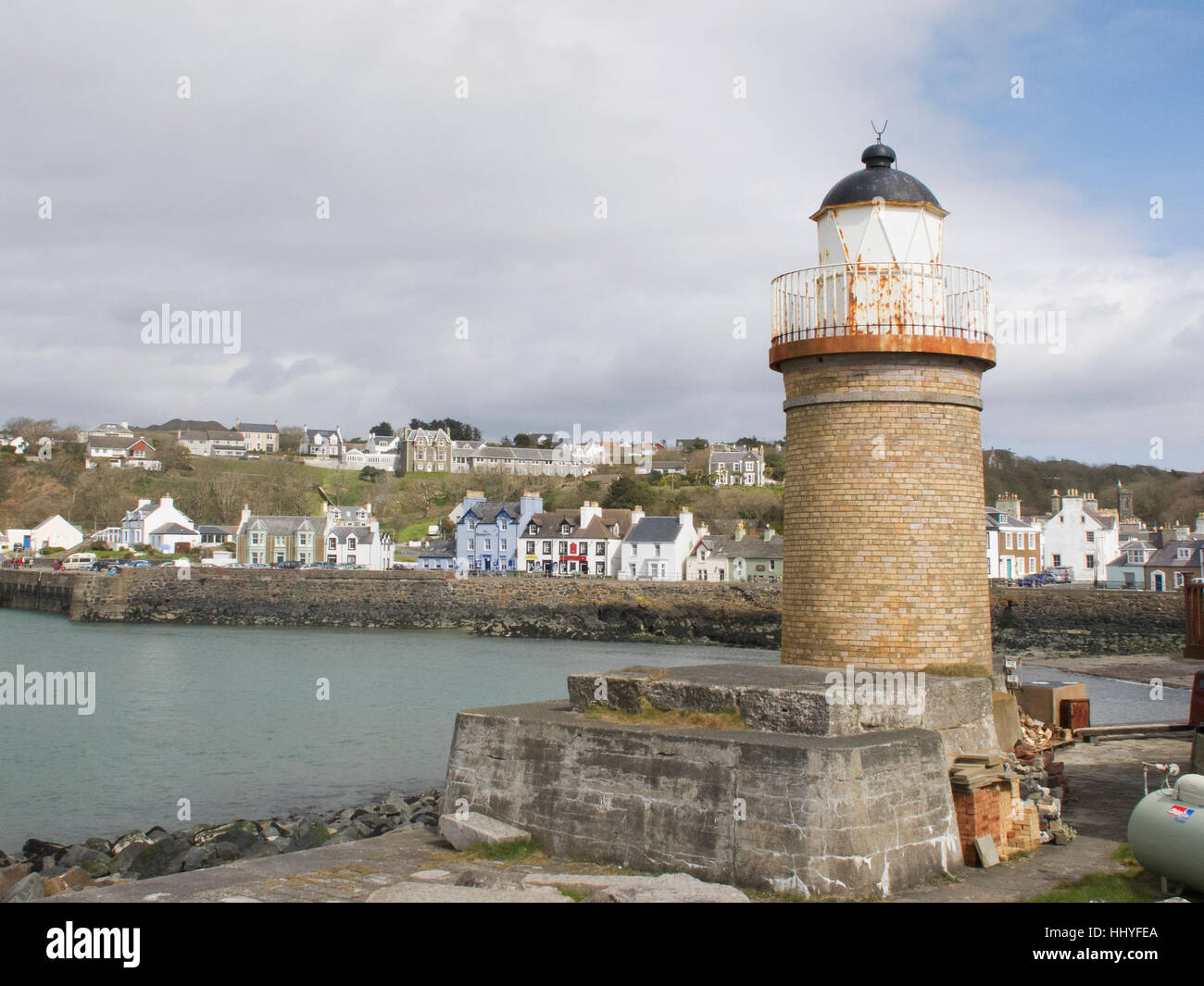 The old pottery lighthouse and harbour at Portpatrick Stock Photo