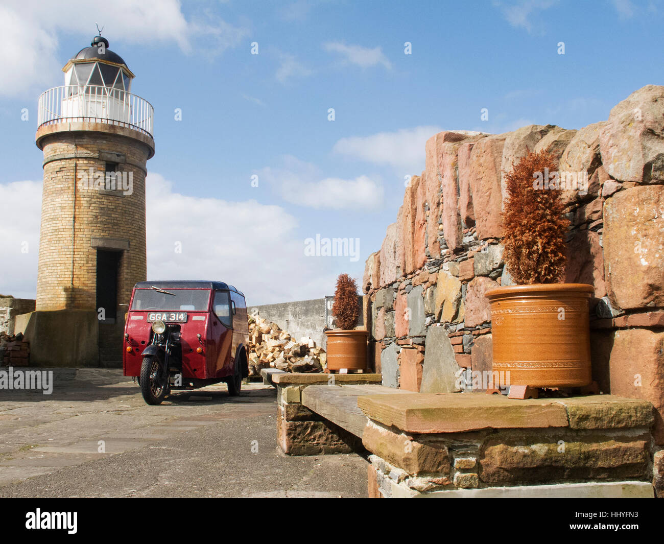 The old lighthouse and harbour at Portpatrick Stock Photo