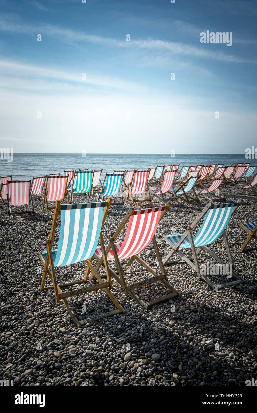 Empty deck chairs arranged on a beach Stock Photo