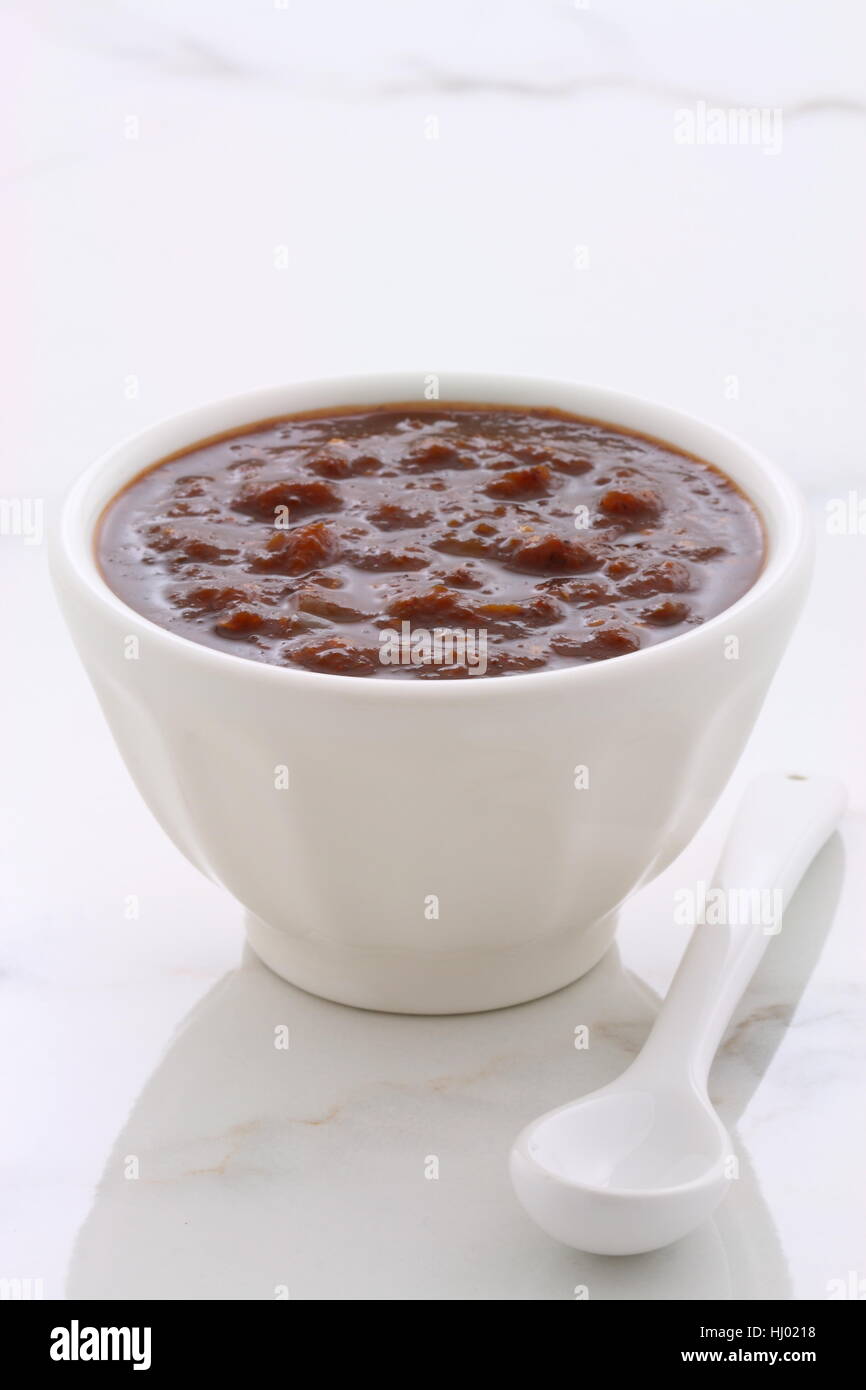 Artisan mexican chipotle sauce on vintage carrara marble table, with a delicious smoky flavor perfect for all your Mexican, tex-mex recipes and sides. Stock Photo