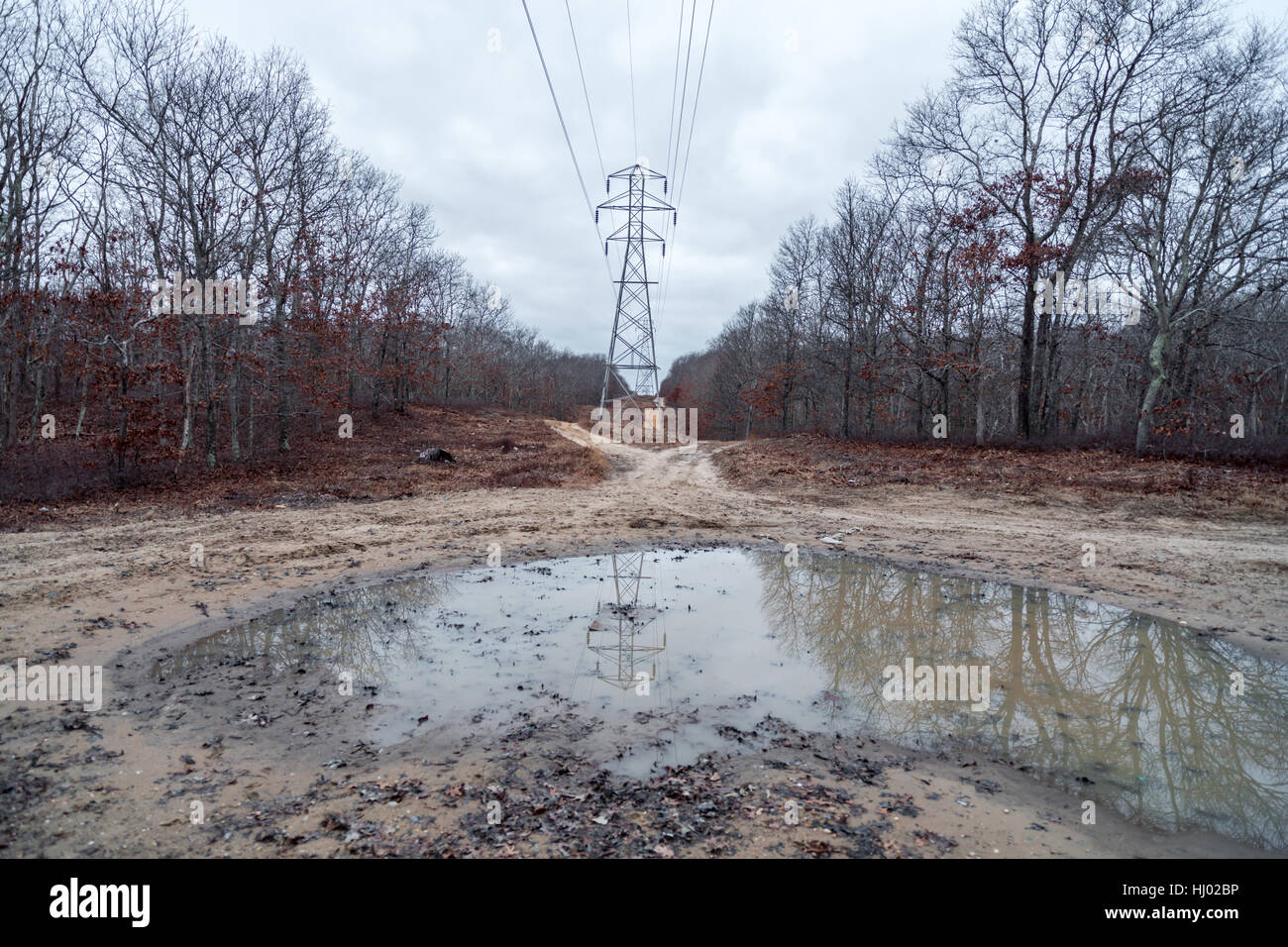 muddy dirt roads that run along a power line road, often used by motorcycles and four wheel drive vehicles Stock Photo