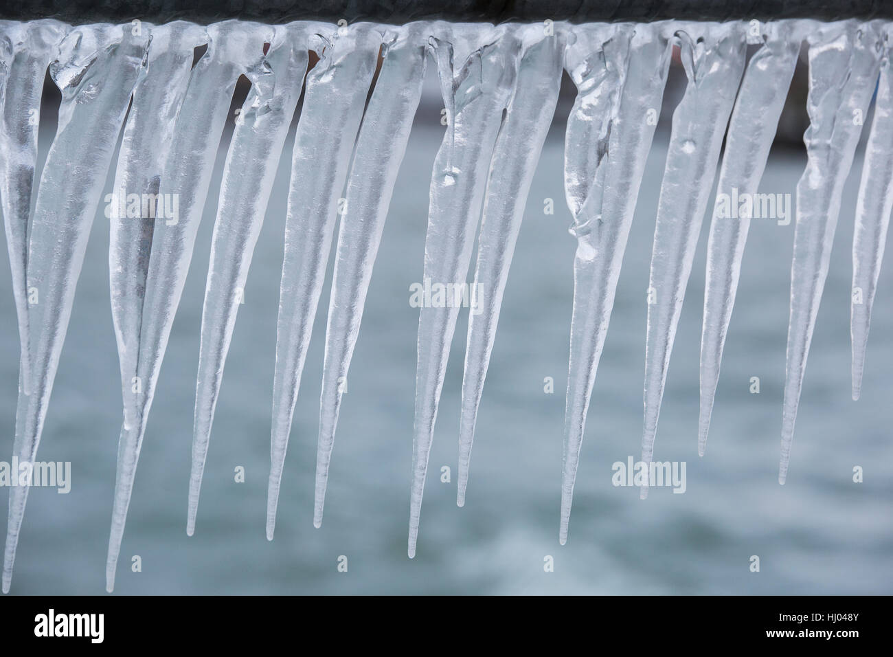 Icicles on a fence after a winter storm on Lake Geneva. Stock Photo