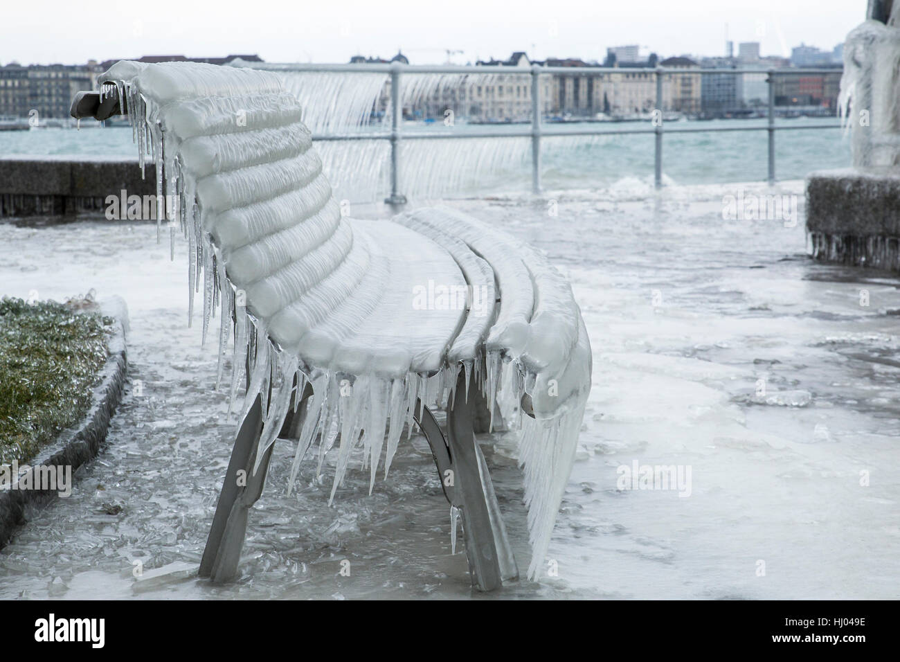 Bench covered with icicles after a winter storm on Lake Geneva. Stock Photo
