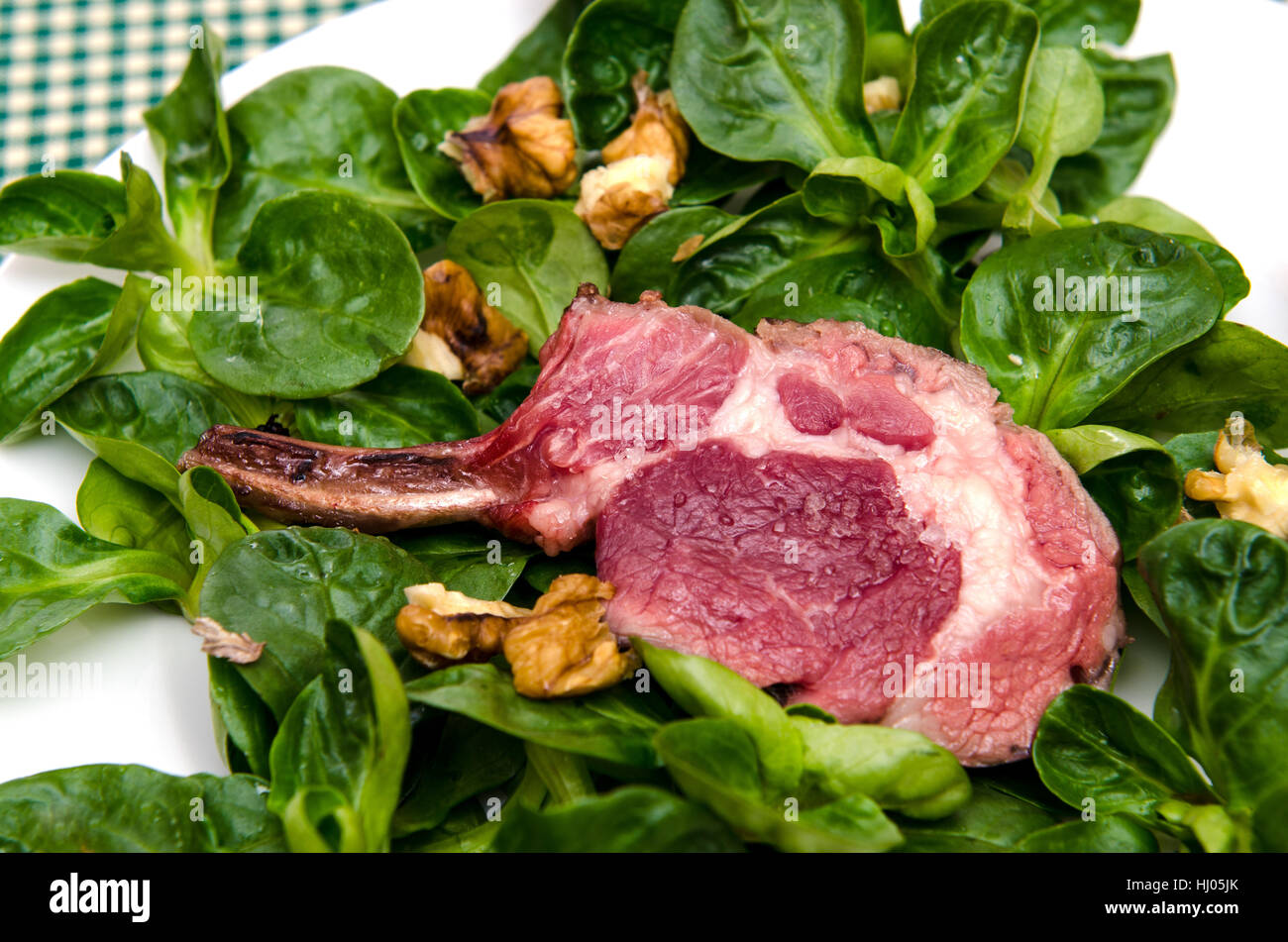 pink lamb chop on corn salad Stock Photo