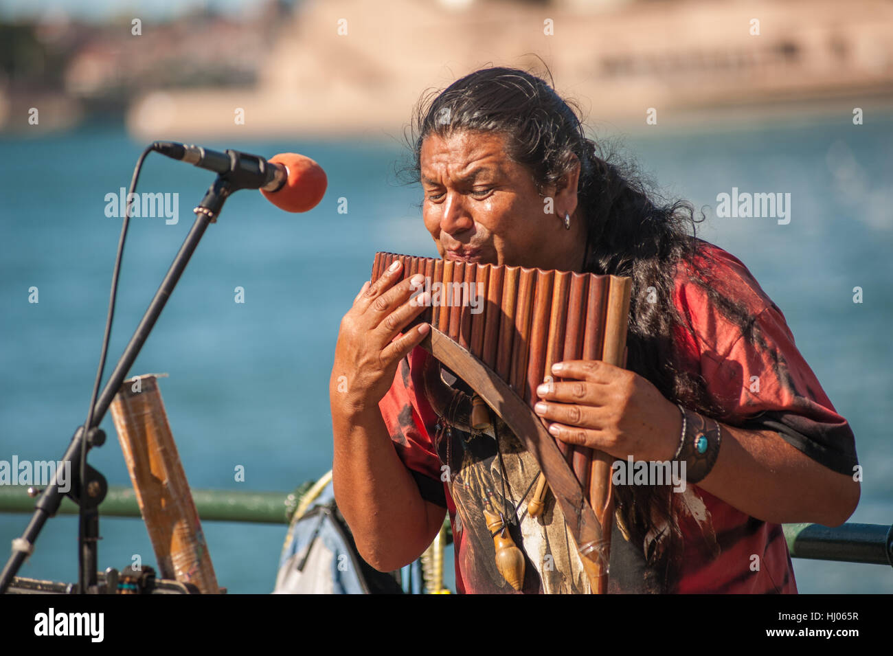 Ecuadorian man playing pan flute along Sydney Harbour, Australia Stock - Alamy