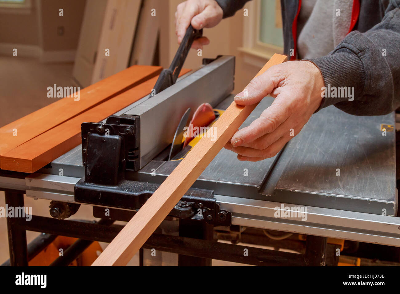 carpenter use ruler to measuring wood board Circular saw cutting wooden ...