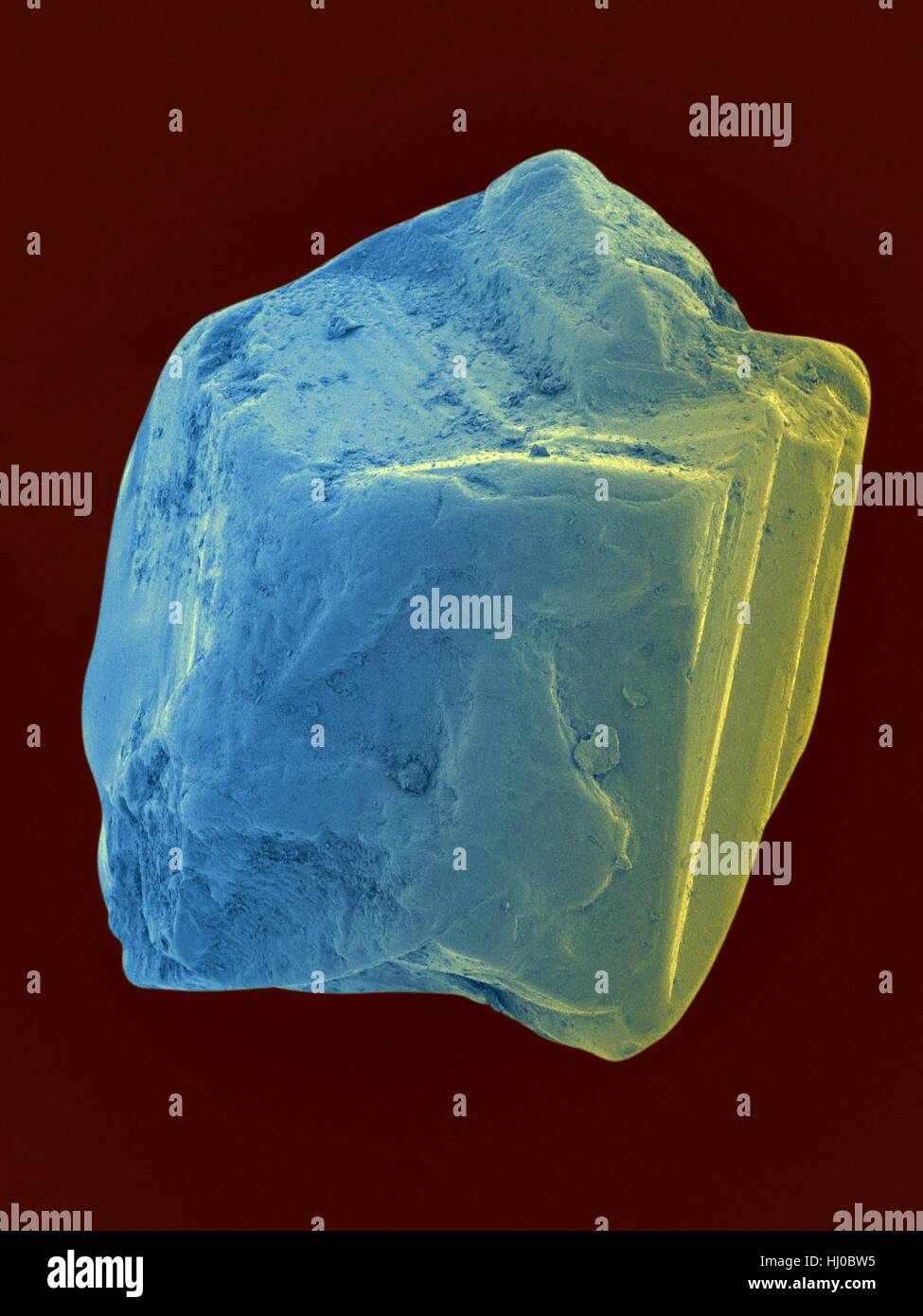 Coloured scanning electron micrograph (SEM) of an uncut sapphire. Sapphire is a typically blue gemstone variety of the mineral corundum (aluminium oxide). Sapphire is very dense and very hard. Non-gem quality sapphire is often used as an industrial abrasive, or as scratch-resistant glass. Magnification: x150 when shortest axis printed at 25 millimetres. Stock Photo
