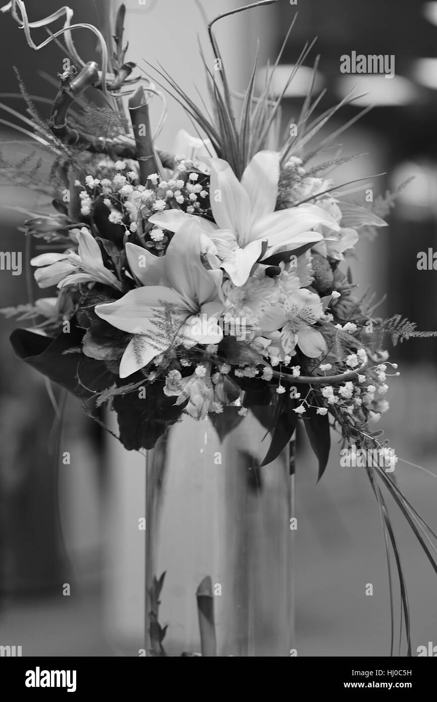 flower arrangement with bamboo in a transparent vase, note shallow depth of field Stock Photo