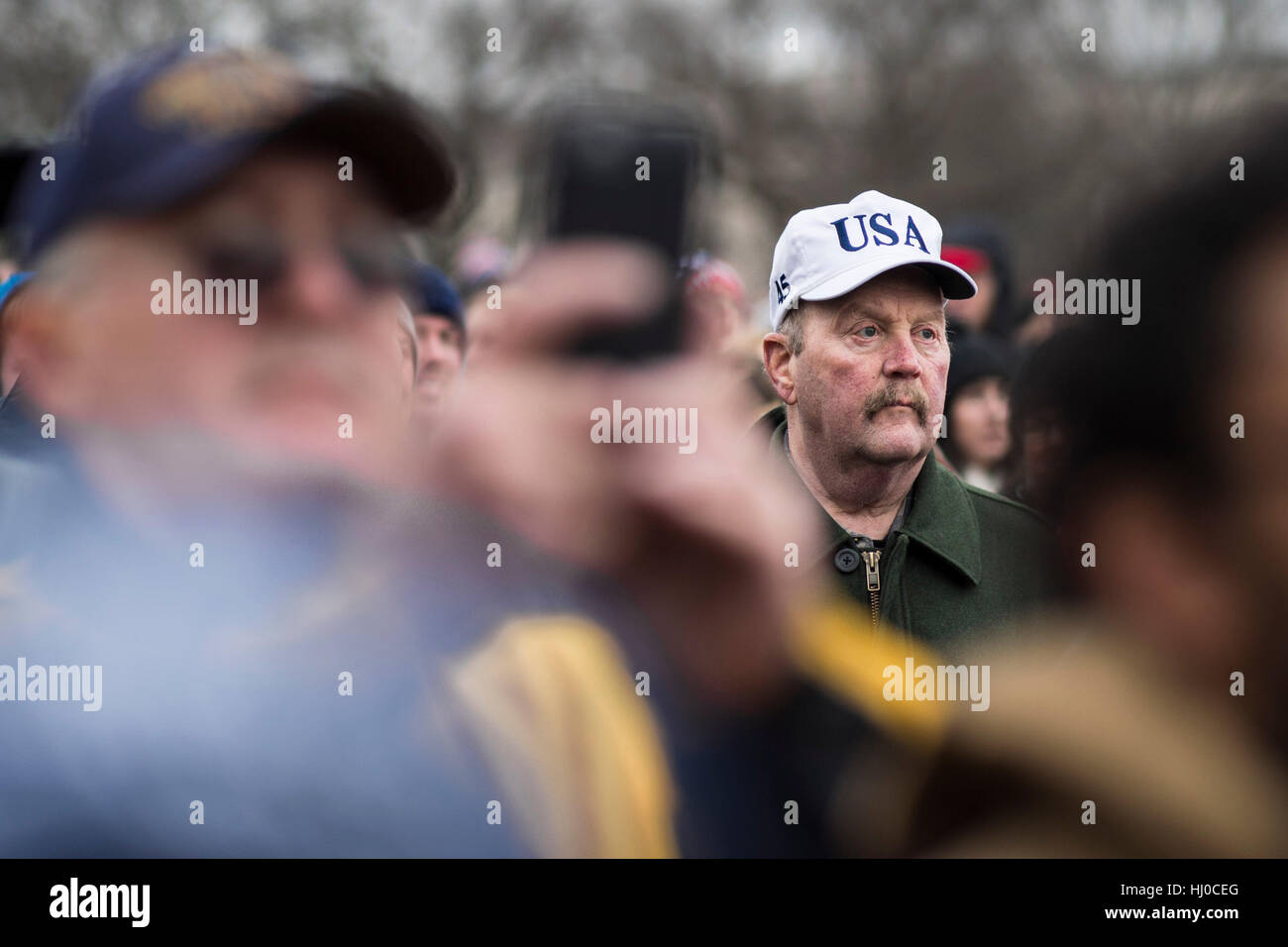 Washington, USA. 20th Jan, 2017 - A man listens to the speech of President Donald Trump during the inauguration ceremony in Washington, D.C. Credit: Gordon M. Grant/Alamy Live News Stock Photo