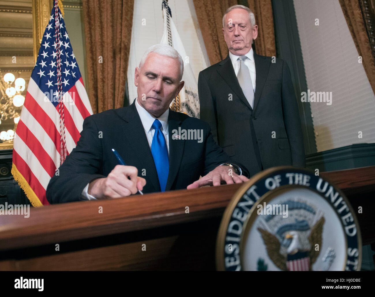 Washington, USA. 20th January, 2017. Vice President Mike Pence signs confirmation paper work for Marine Corps General James Mattis, after swearing him in as Defense Secretary, in the Vice Presidential ceremonial office in the Executive Office Building in Washington, DC on January 20, 2017. Photo by Kevin Dietsch/UPI /CNP/MediaPunch Credit: MediaPunch Inc/Alamy Live News Stock Photo