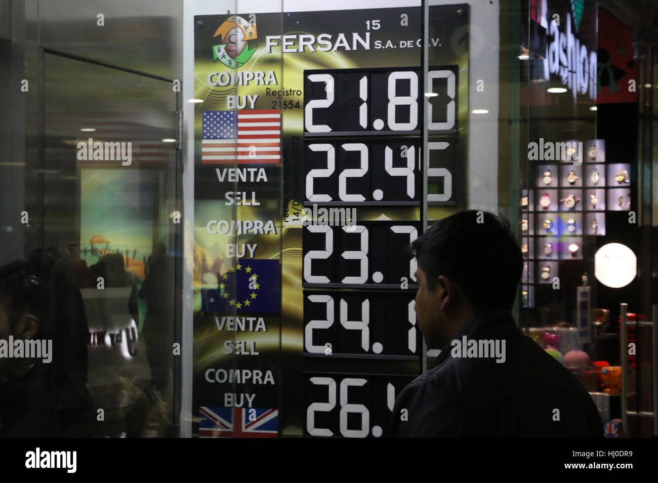 Mexico City, Mexico. 20th Jan, 2017. A man looks at a billboard showing the price of the Mexican peso against the U.S. dollar, in an exchange house at the International Airport of Mexico City, capital of Mexico, Jan. 20, 2017. One U.S. dollar was sold up to 23 Mexican pesos at the airport, prior to Donald Trump's inauguration as the U.S. president on Friday. Credit: Hector Alfaro/ObturadorMX/Xinhua/Alamy Live News Stock Photo