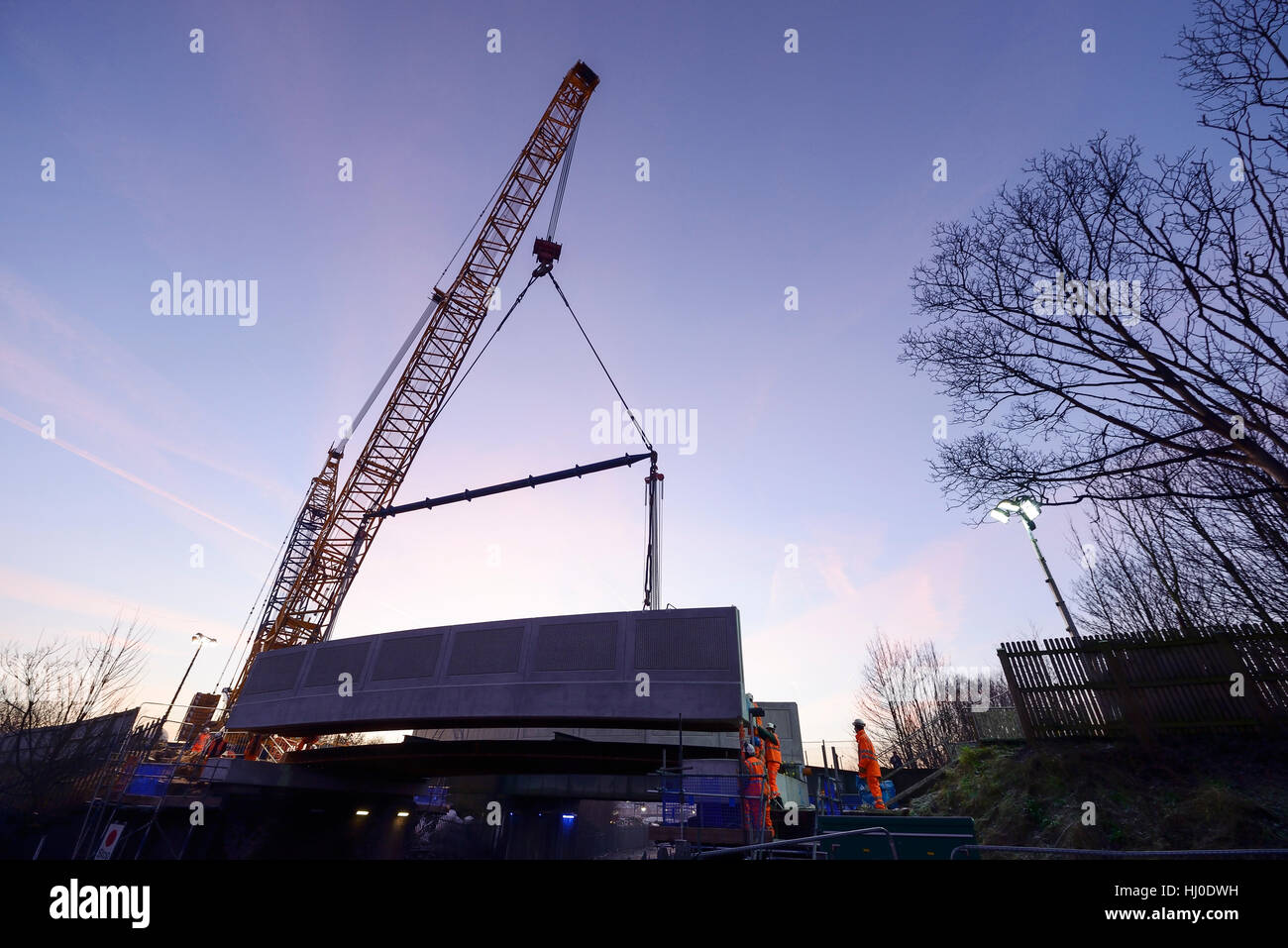 Chester, UK. 21st January 2017. Installation of a concrete road bridge at first light on Brook Lane over the Merseyrail Wirral Line in Chester, UK ©Andrew Paterson / Alamy Live News Stock Photo