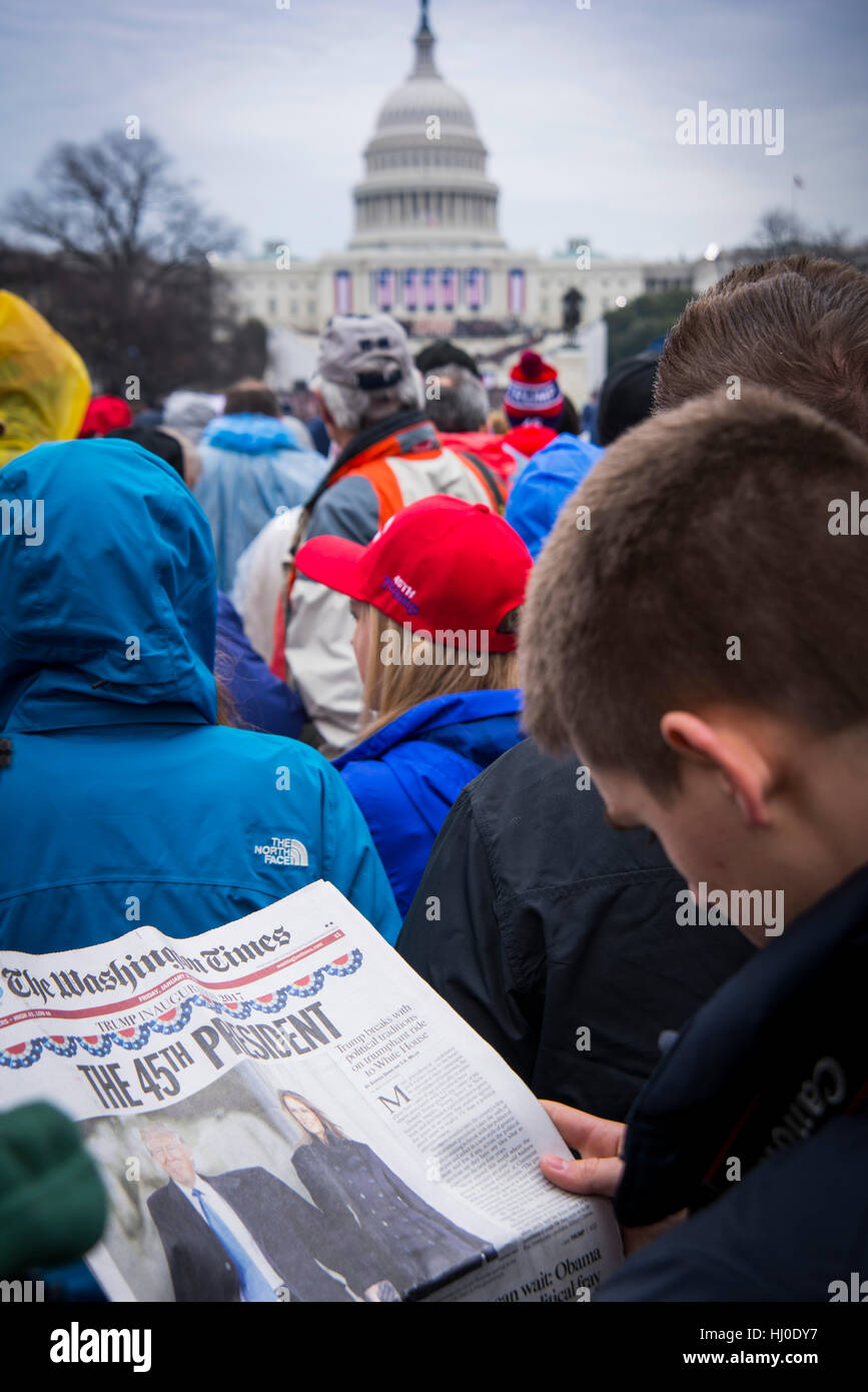 Washington DC, USA. 20th Jan, 2017. Inauguration day. Man reading The Washington Times during Donald Trump's inauguration at Capitol Hill. 58th sworn in ceremony. Trump becomes 45th President of the United States. Credit: Yuriy Zahvoyskyy/Alamy Live News Stock Photo