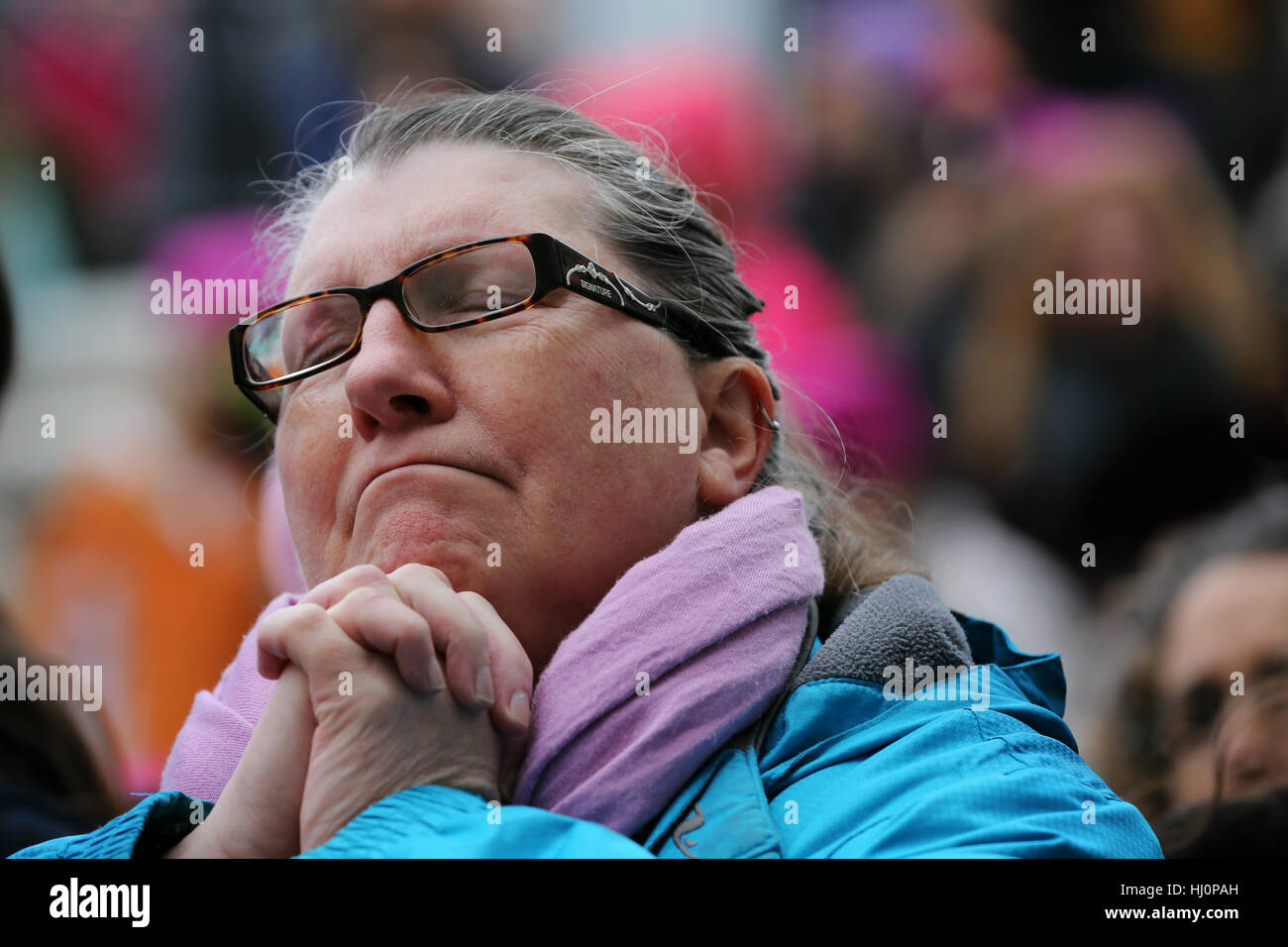 Kingston, Canada. 21st Jan, 2017. A woman prayers during one of the speaker during the Women's march in Kingston. The march is in support with the Women's march in Washington, D.C. Credit: Lars Hagberg/Alamy Live News Stock Photo