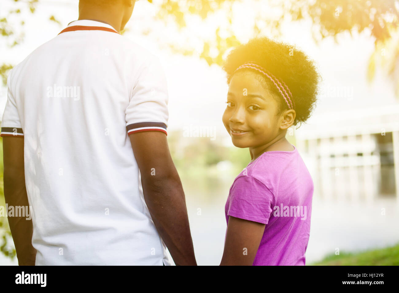 Father holding hands of daughter - African American family Stock Photo ...