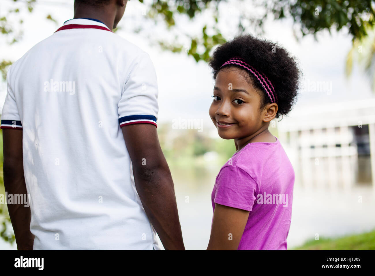 Father holding hands of daughter - African American family Stock Photo ...