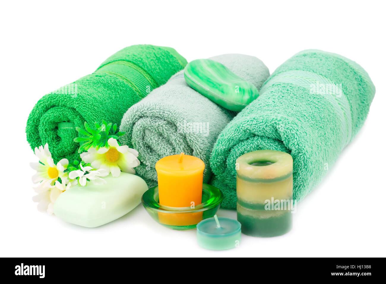 Spa set with towels, soaps, candles and flowers isolated on white background. Stock Photo