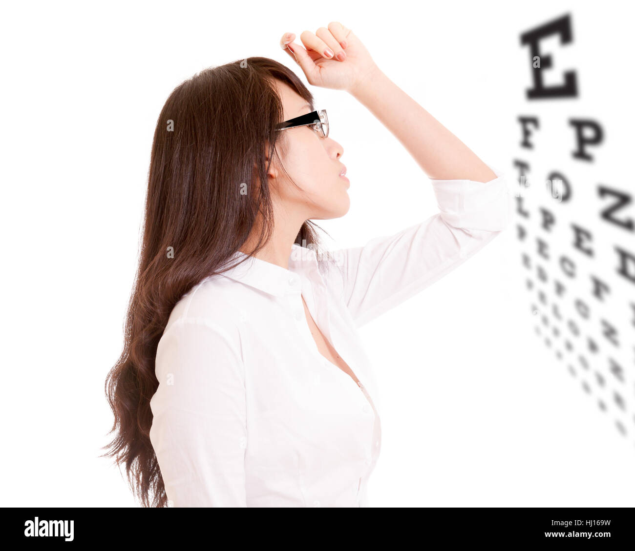 Sode profile of Chinese businesswoman wearing glasses looking at eyechart Stock Photo