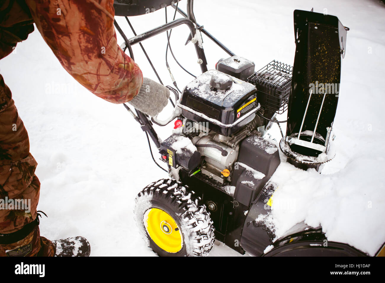 man starts the engine snow blower Stock Photo Alamy