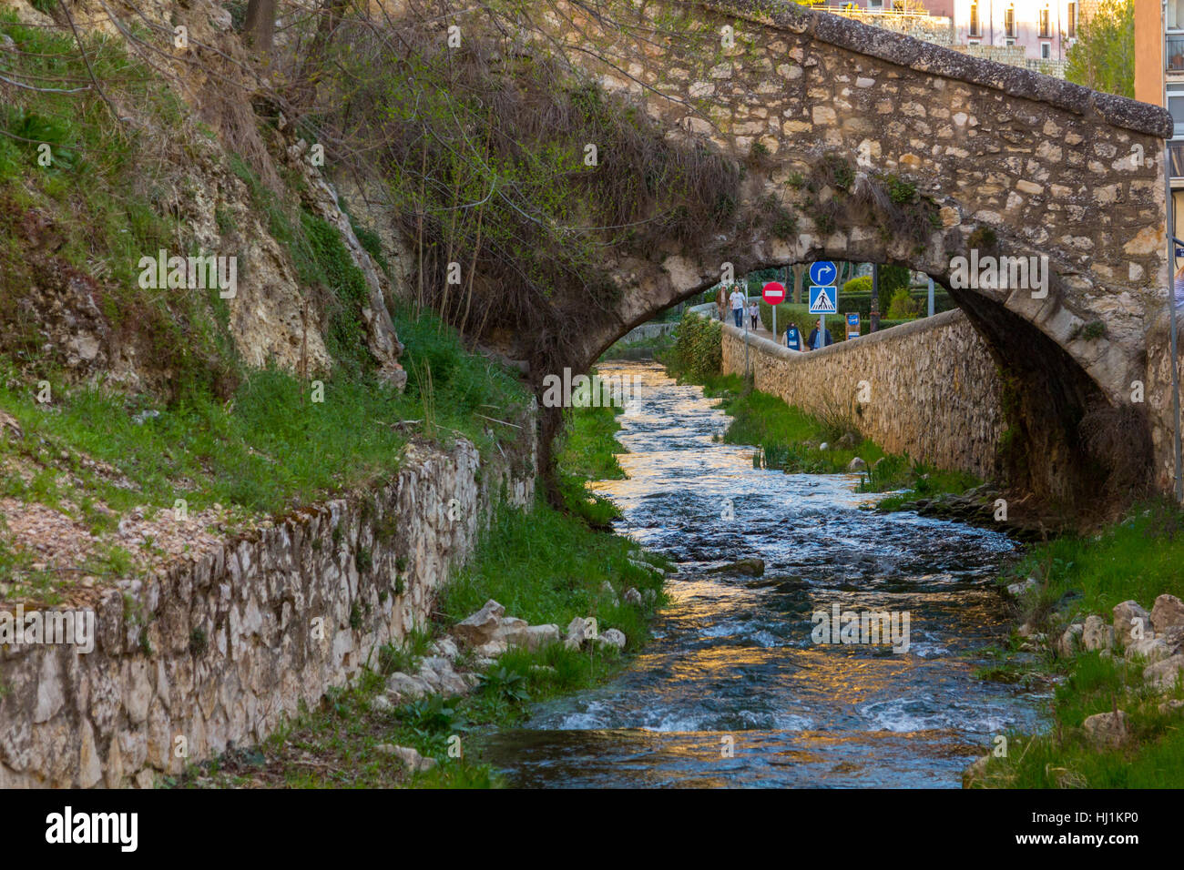 Arch stone bridge and pedestrian in the city of Cuenca, Spain Stock Photo