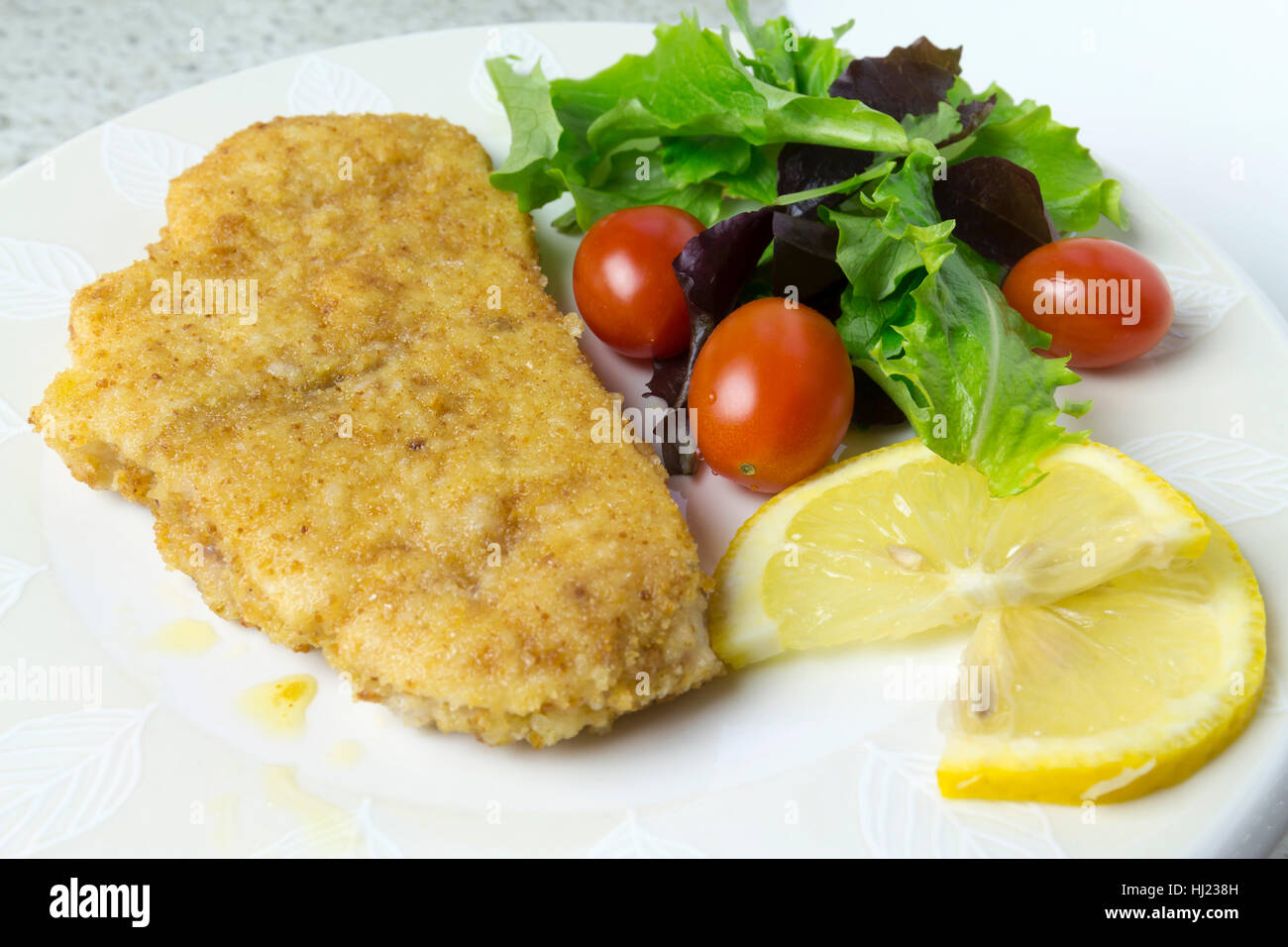 swordfish steak with salad, tomatoes and lemon Stock Photo Alamy