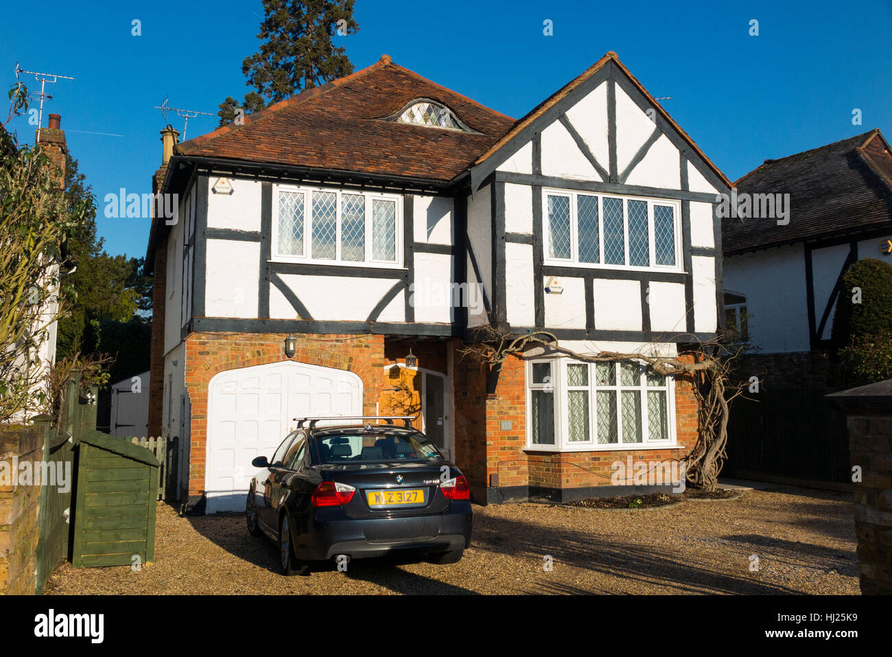 Mock Tudor 1930's house with car on the drive, and garage, in Esher