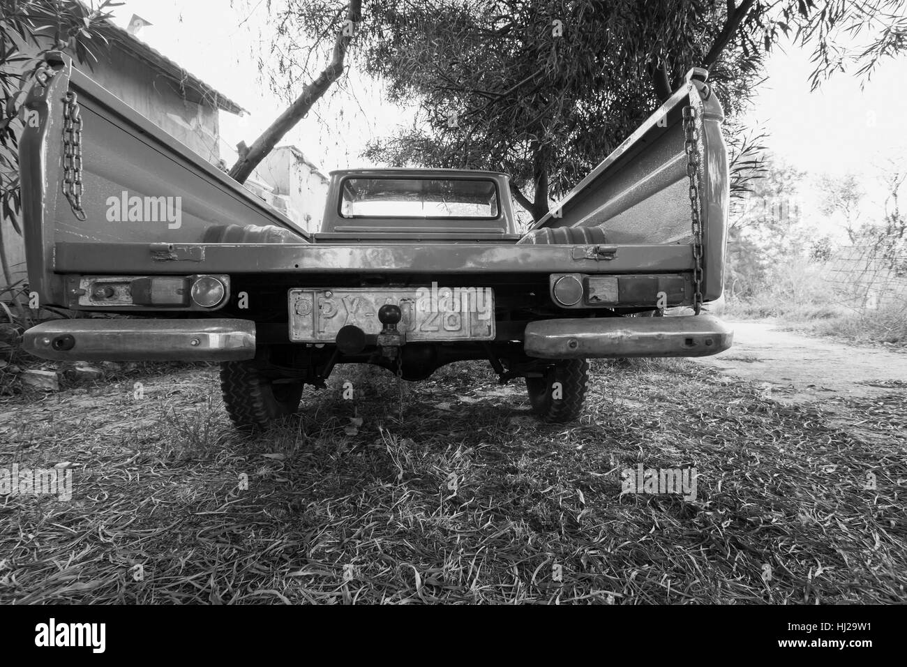 Zakynthos, Greece - August 16, 2016: Rear view of old Datsun 1300 pickup car, black and white photo Stock Photo