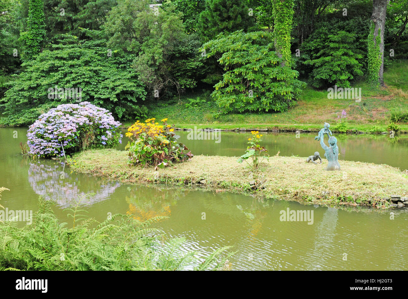 Lake, island and statues, Marwood Hill Gardens, North Devon Stock Photo