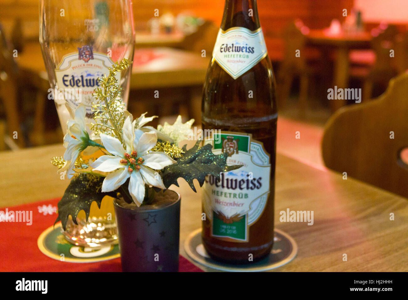 VIENNA, AUSTRIA - JANUARY 2 2016: Edelweiss beer glass and bottle in a  little rustic pub in Vienna, Austria, nobody around Stock Photo - Alamy
