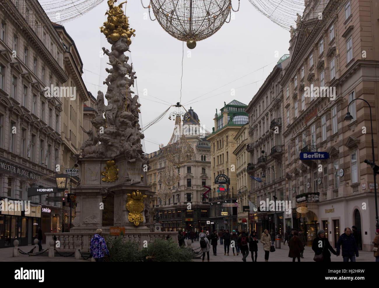 VIENNA, AUSTRIA - JANUARY 3 2016: Vienna city centre at day time in winter season: Graben street full of people with Pestsaule monument in the foregro Stock Photo