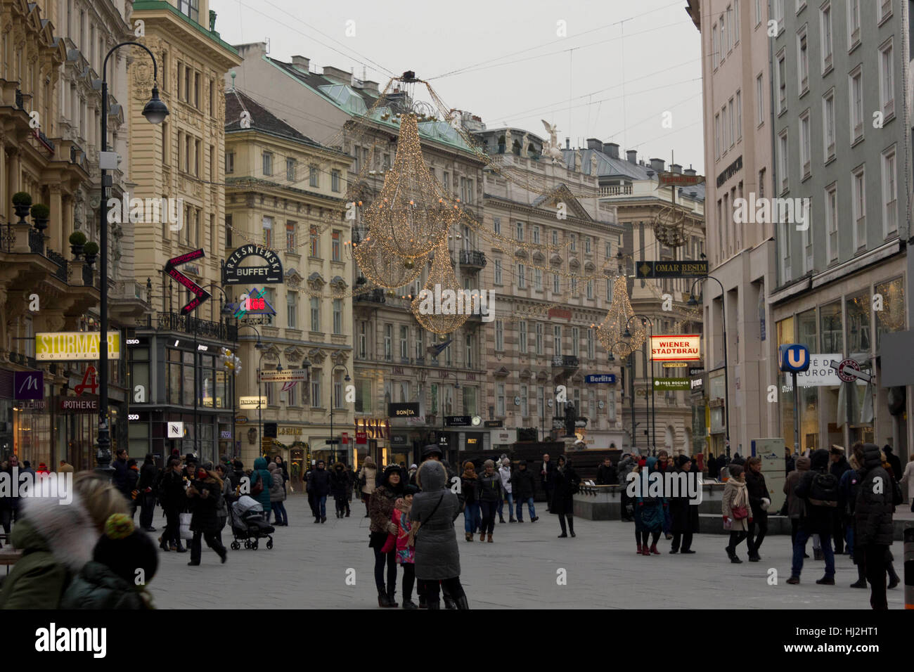 VIENNA, AUSTRIA - JANUARY 3 2016: Day view of Graben street in Vienna in the late afternoon, with the light decoration on and people around Stock Photo