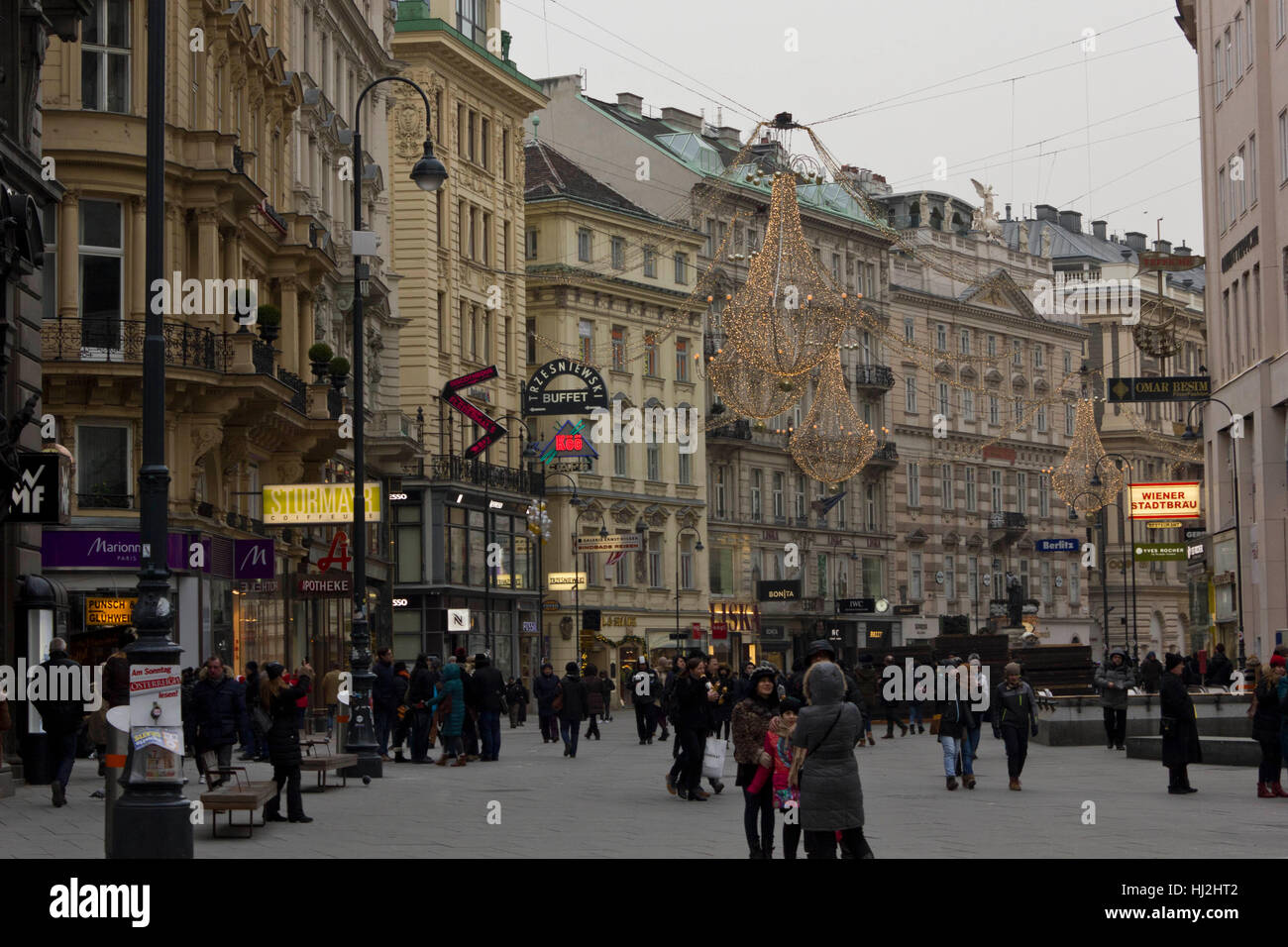 VIENNA, AUSTRIA - JANUARY 3 2016: Day view of Graben street in Vienna in the late afternoon, with the light decoration on and people around Stock Photo