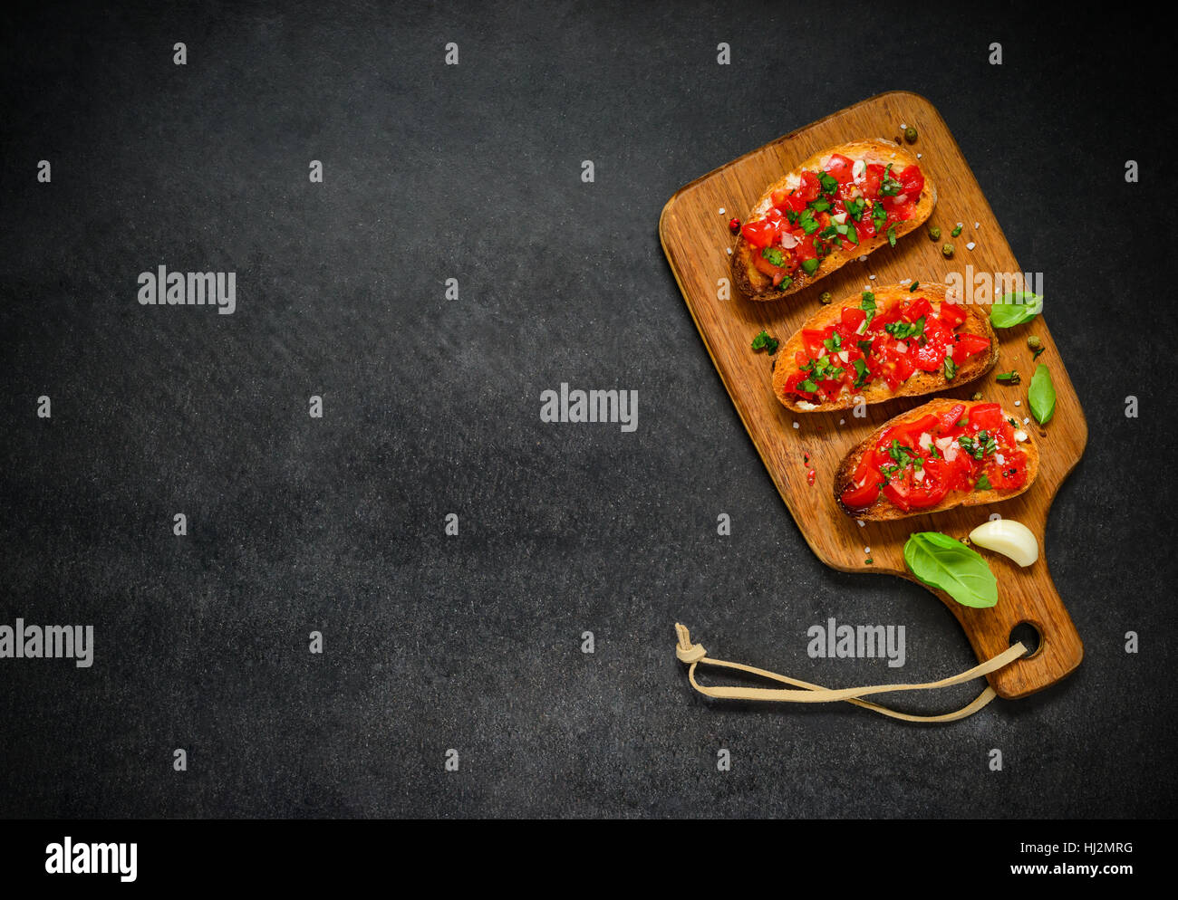 Bruschetta Italian Antipasto with Tomato and Basil on Copy Space Text Area Stock Photo