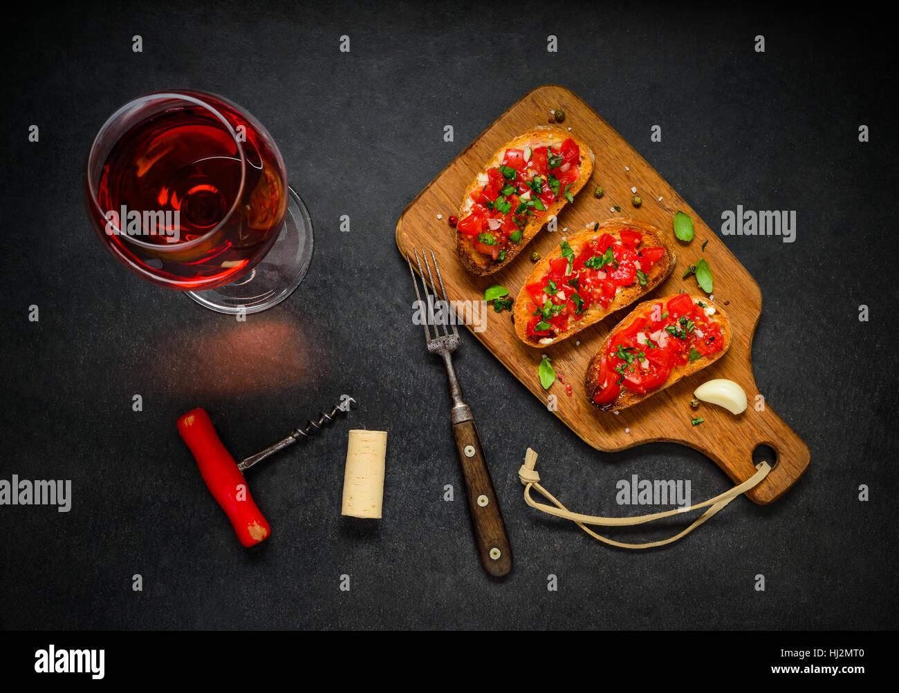 Iatlian Cuisine Bruschetta with Tomato, Basil and Rose Wine. Stock Photo