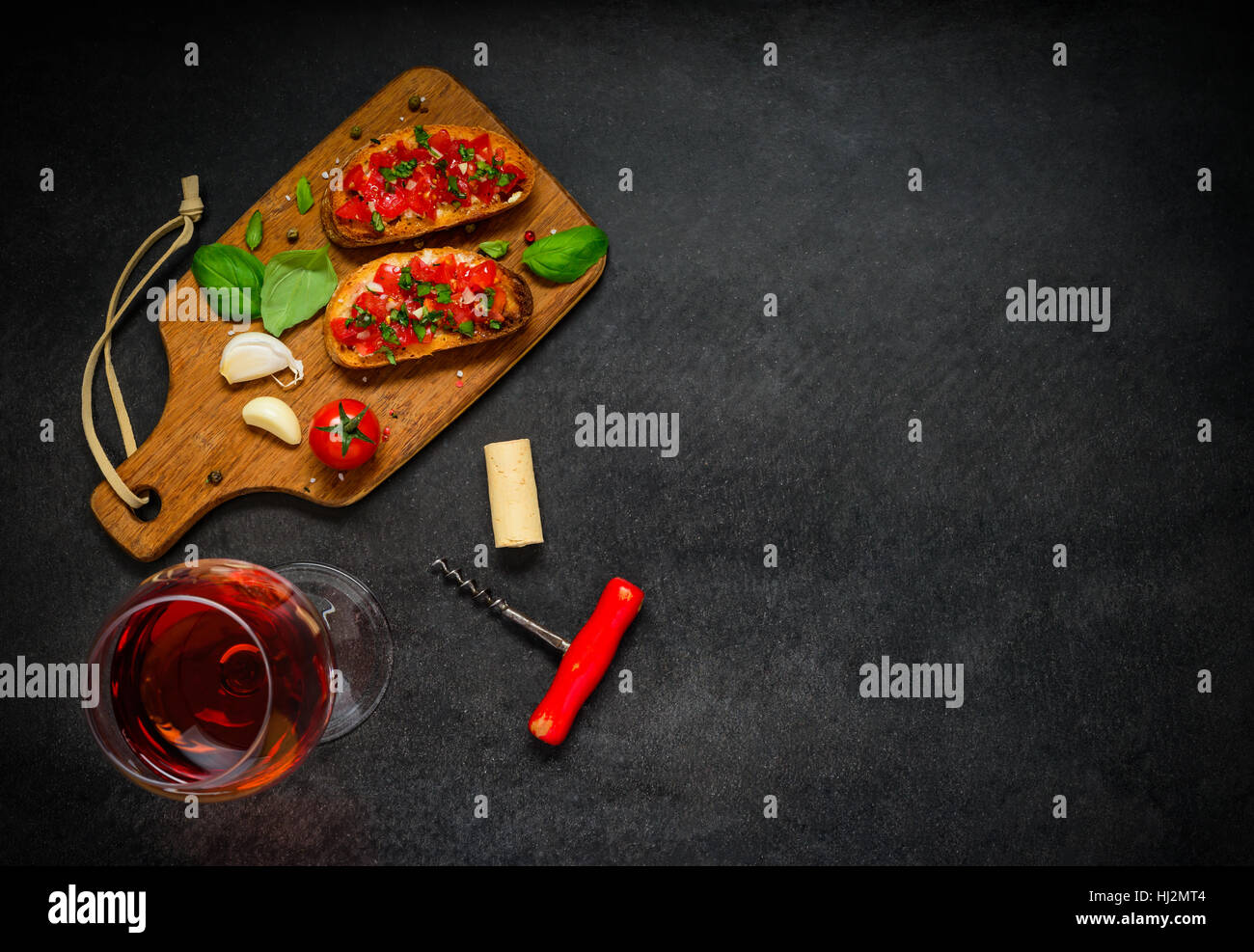 Bruschetta Italian Cuisine Antipasto with Tomato, garlic and basil with Rose Wine on Copy Space Area Stock Photo