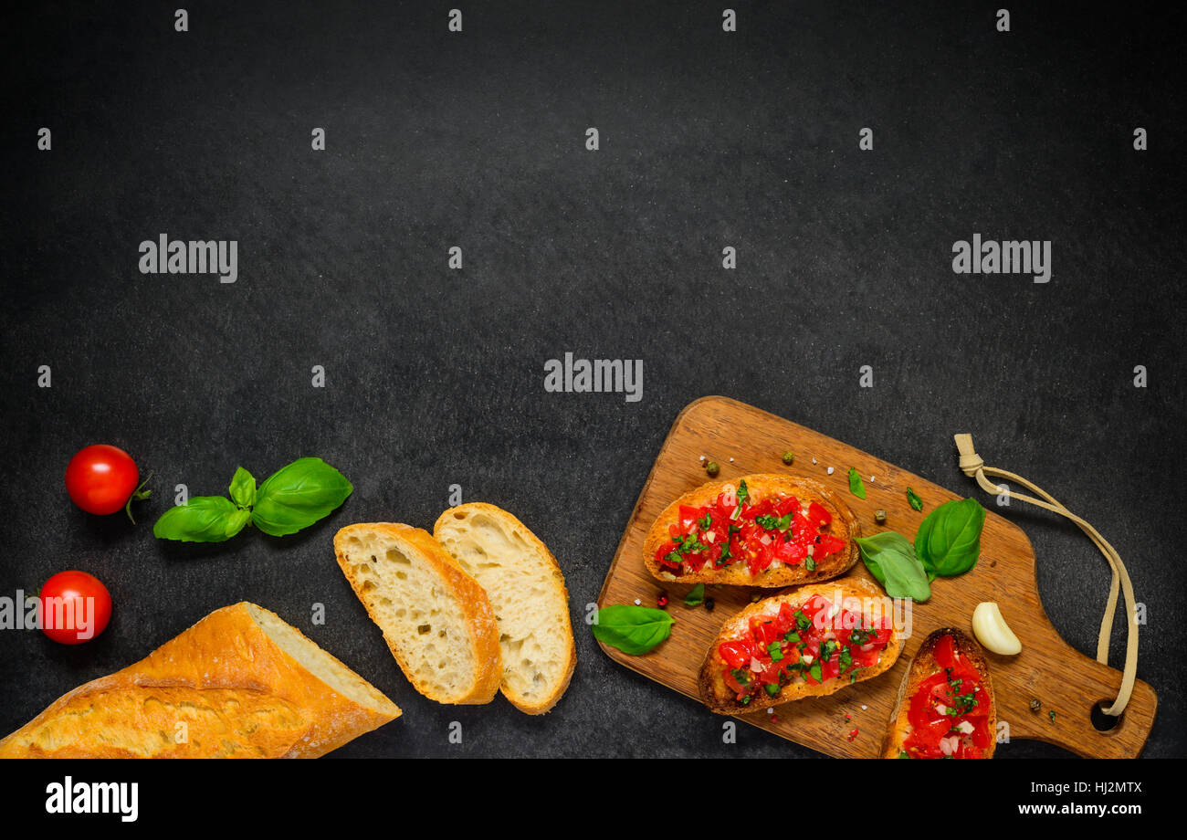Bruschetta Antipasto with French Bread, Tomatoes and Basil on Copy Space Text Area Stock Photo