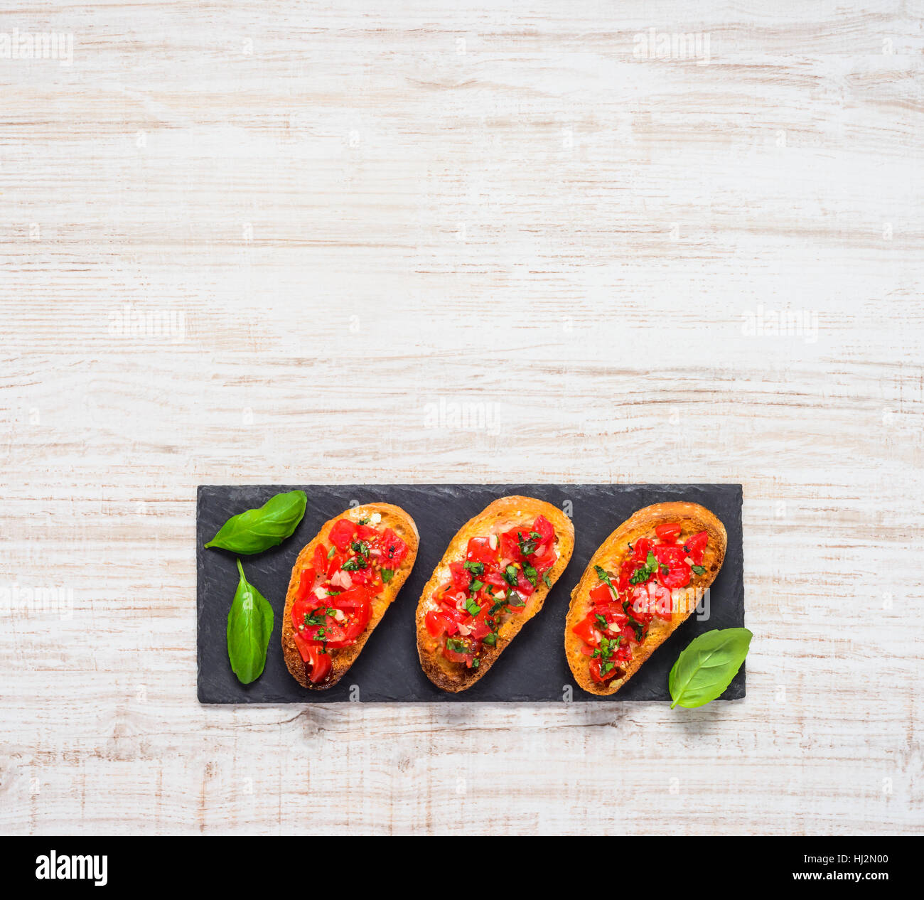 Italian Bruschetta with Tomato, Garlic and Basil in Top View Copy Space Text Area Stock Photo
