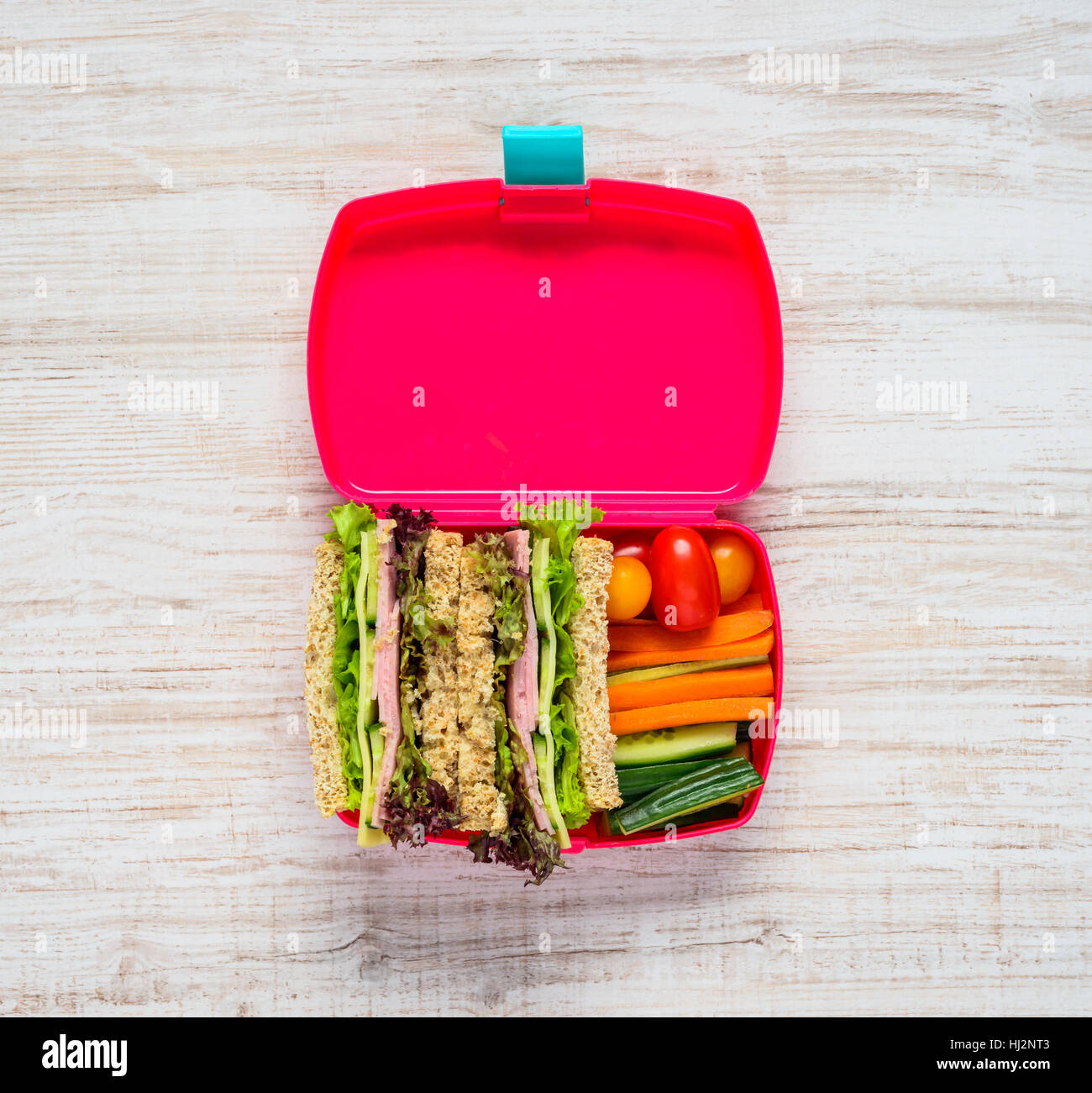 Top View Of Open Pink Lunch Box With Sandwich And Vegetables Top View Of Open Pink Lunch Box With Sandwich And Vegetables