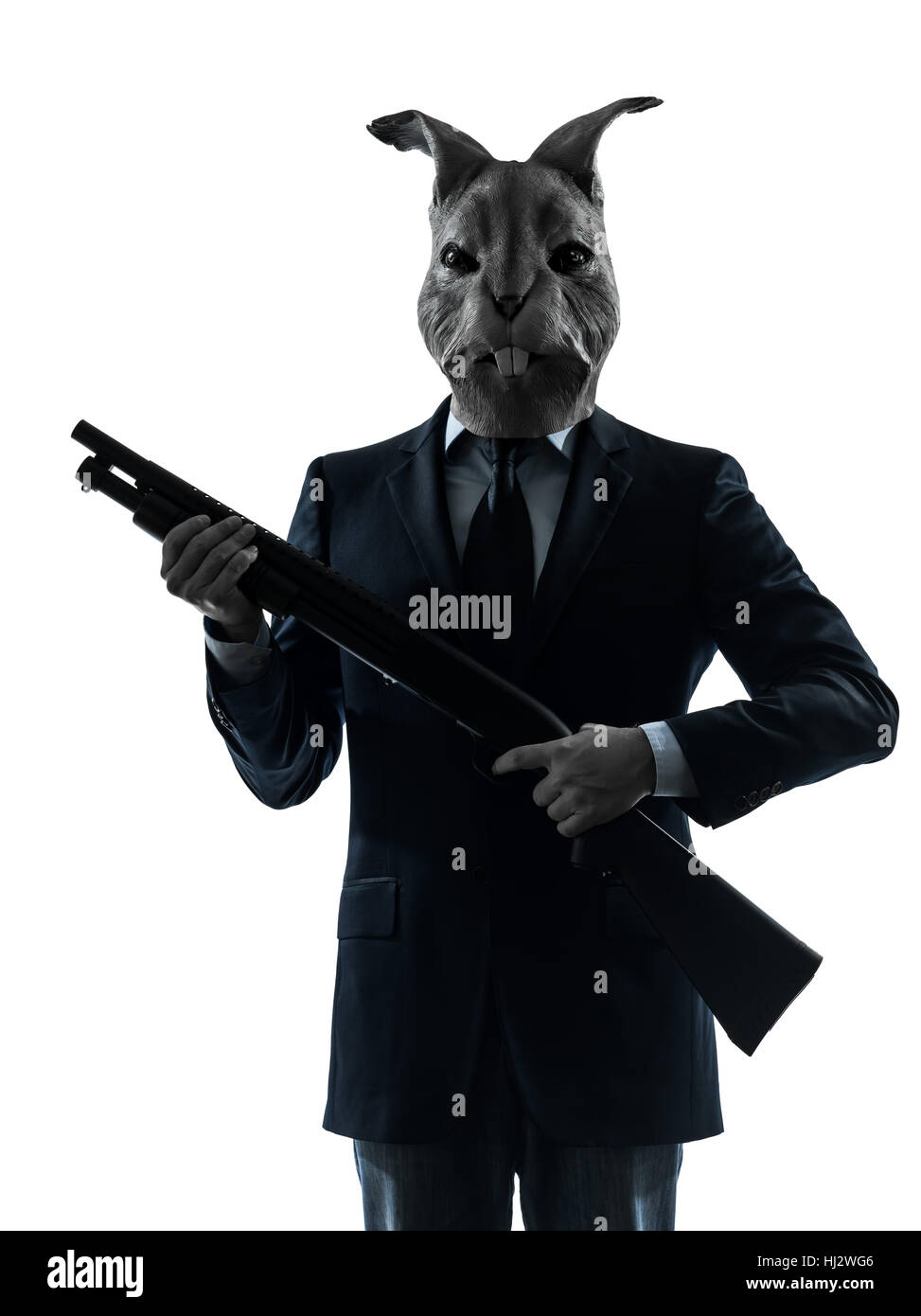 one causasian man rabbit mask hunting with shotgun portrait in