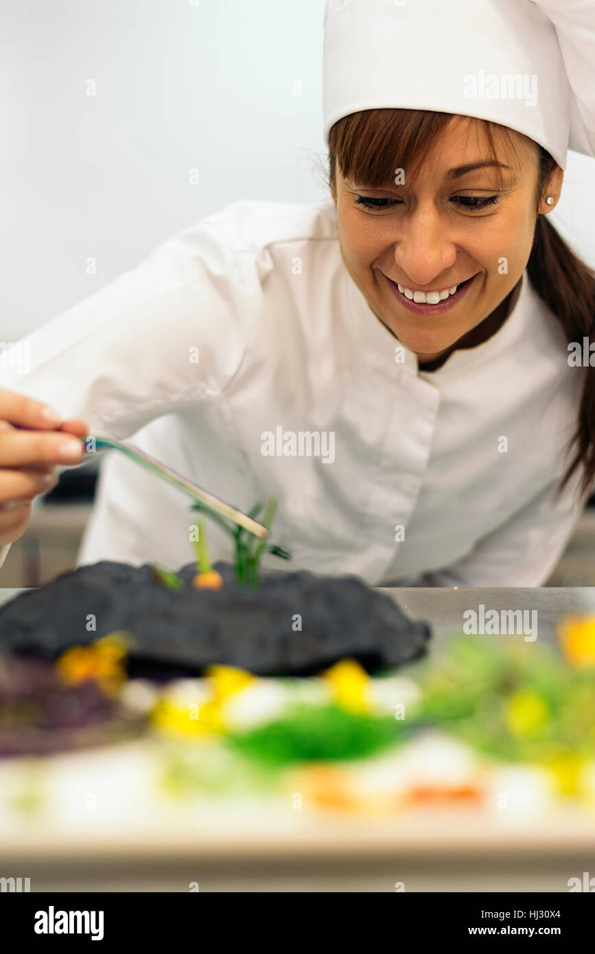 Pretty professional chef cooking in a kitchen Stock Photo - Alamy