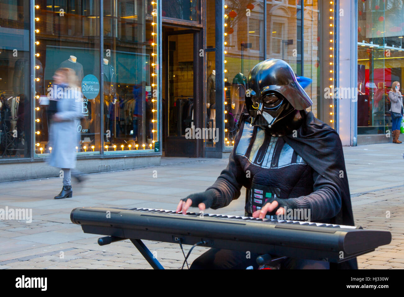 Black costumed Darth Vader Busker; Musician playing Roland keyboard and ...