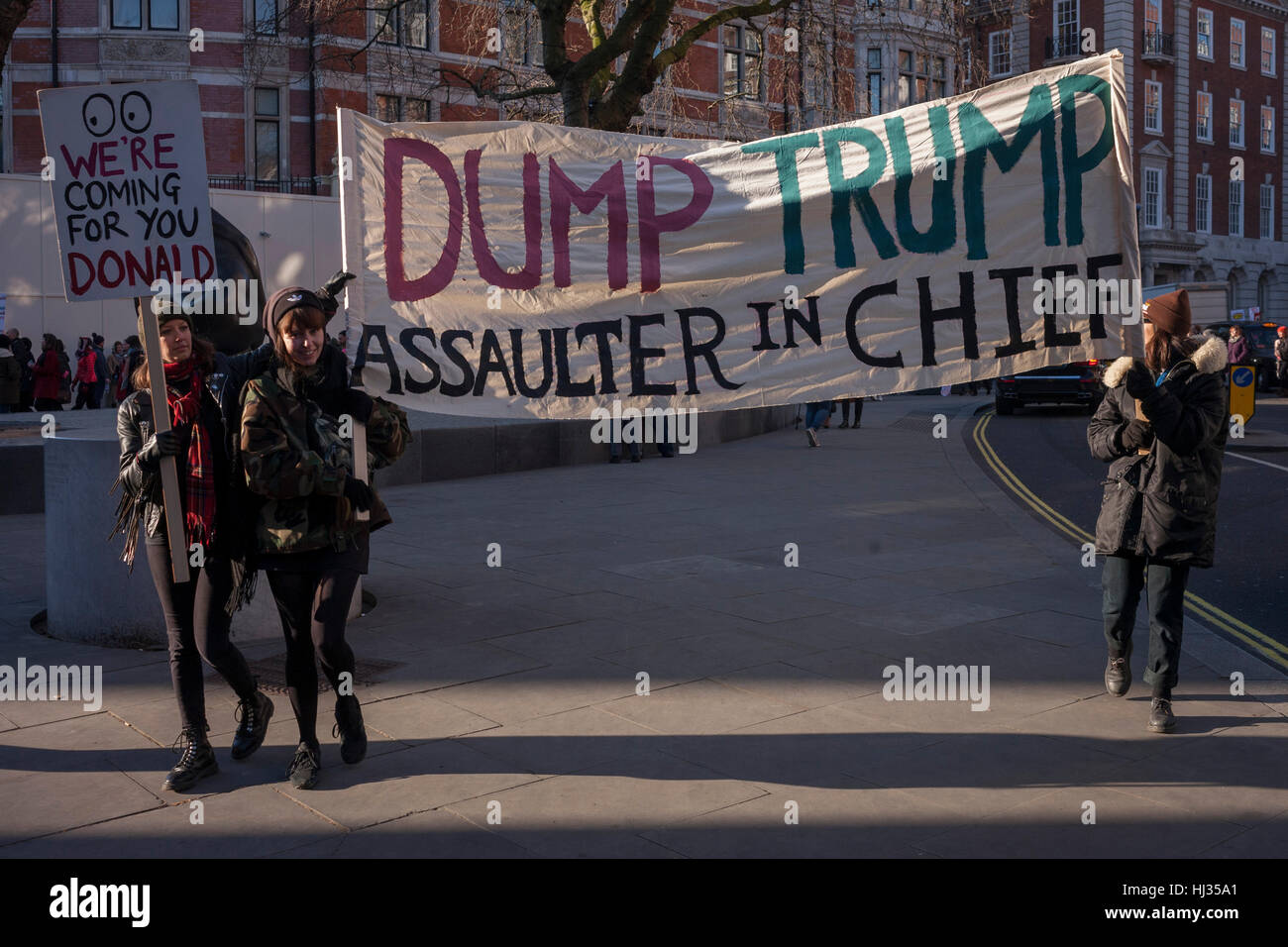 Women protesters march through central London as part of an international campaign on the first full day of Donald Trump's presidency, on 21st January 2017, in London, England. They marched from the US embassy in Mayfair, to Trafalgar Square for a rally, held in solidarity with a march in Washington and other cities around the world. Organisers say it highlighted women's rights, which they perceive to be under threat from the new US administration. London organisers announced on stage that between 80,000 and 100,000 people - which included both men and women - had taken part in the rally. Stock Photo