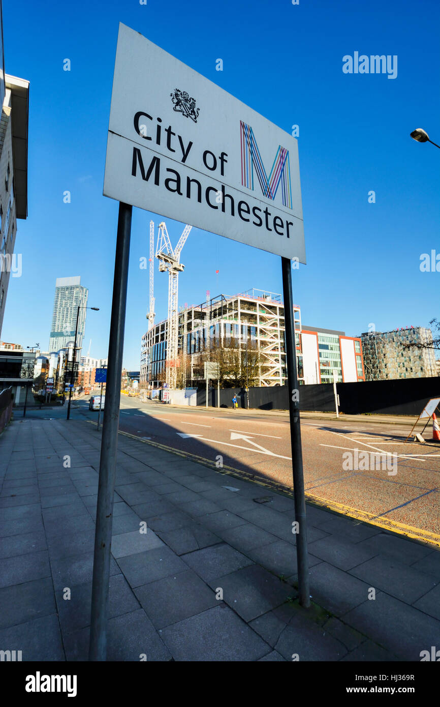 City of Manchester sign on Medlock Street, Manchester City centre with construction site in background. Stock Photo