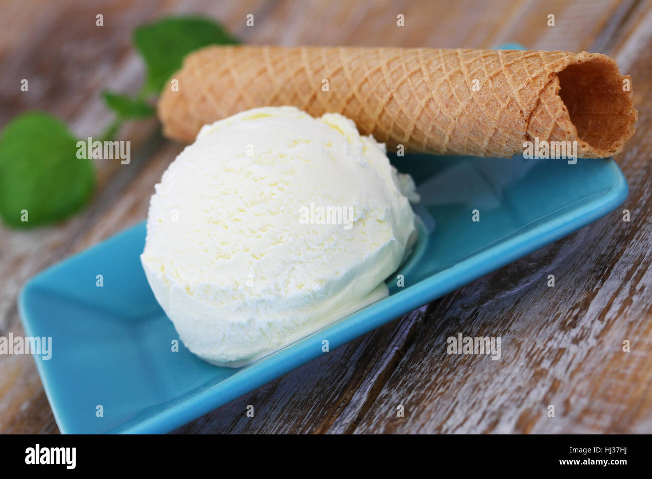 Scoop of delicious, creamy vanilla ice cream and crispy wafer, closeup Stock Photo