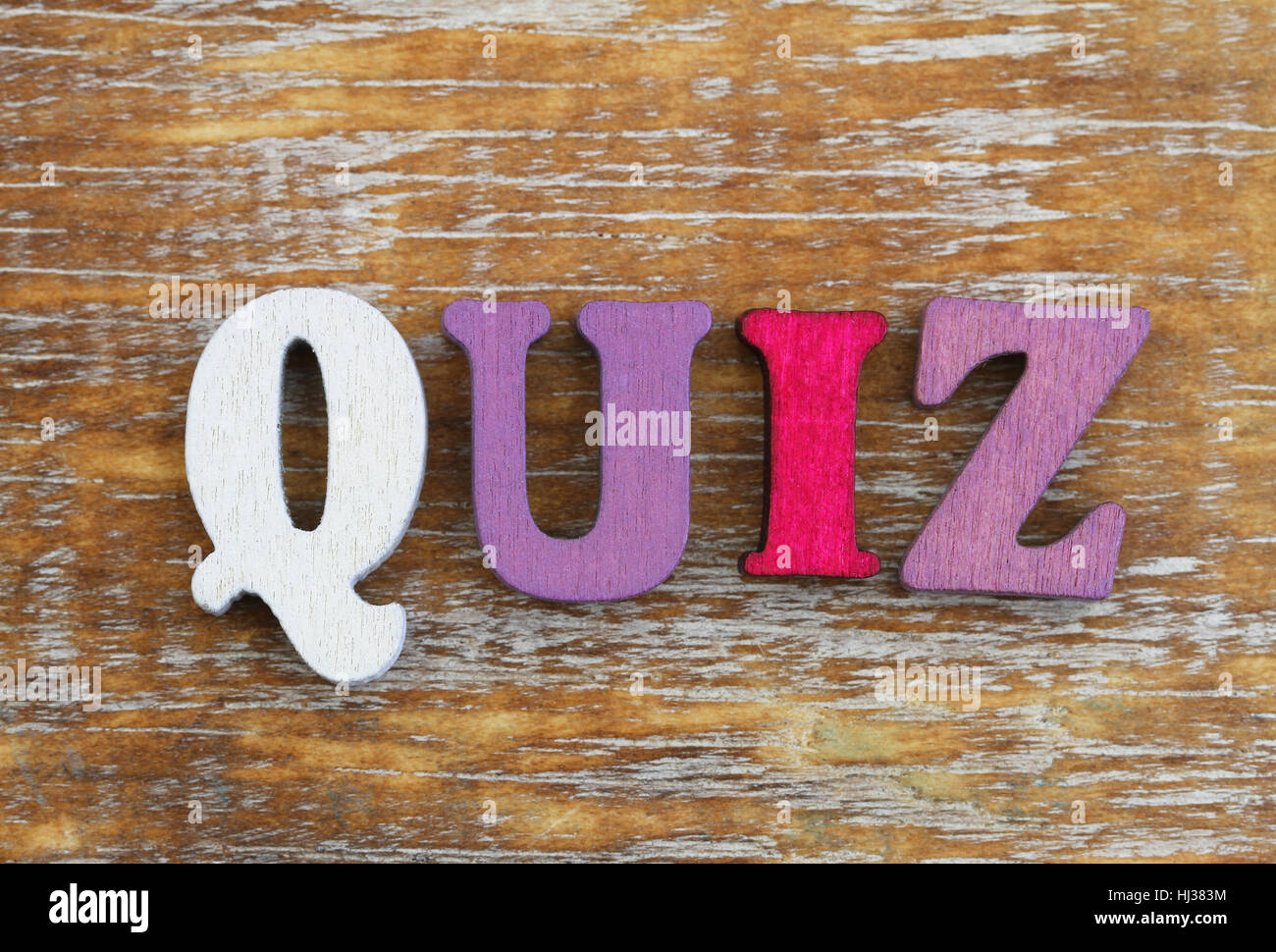 Word quiz written with colorful letters on rustic wooden surface Stock Photo
