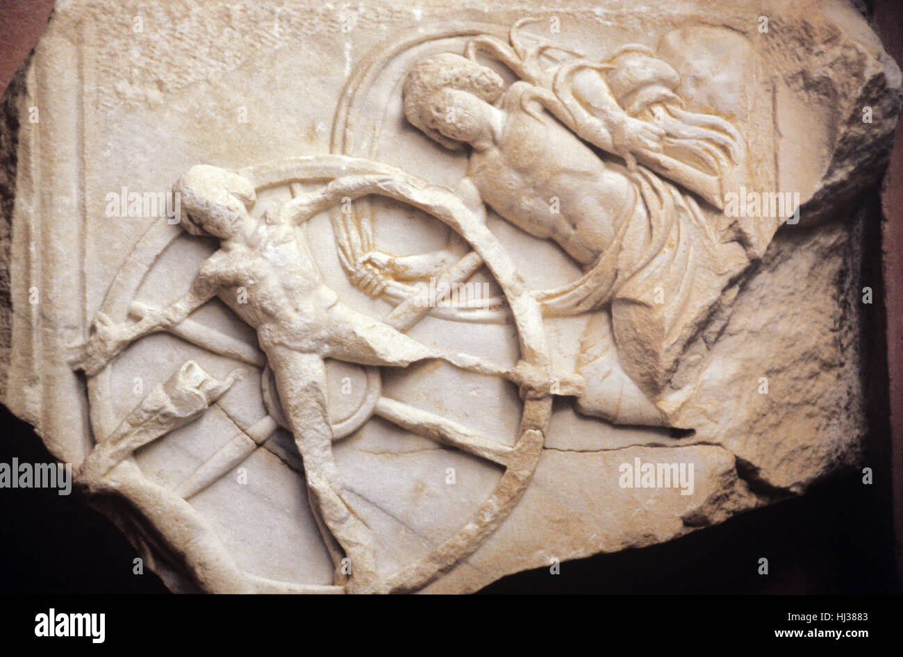 The Punishment of Ixion. c2nd AD Greek Marble Carving from Side, southern Turkey. In Greek Mythology Ixion, King of the Lapiths of Thessaly, was condemned to Eternal Punishment in Tartarus by being Chained to A Fiery Wheel, Execution Wheel or Breaking Wheel aka a Catherine Wheel Stock Photo