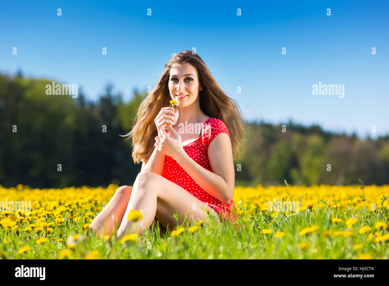 girl in the spring on a flower meadow Stock Photo