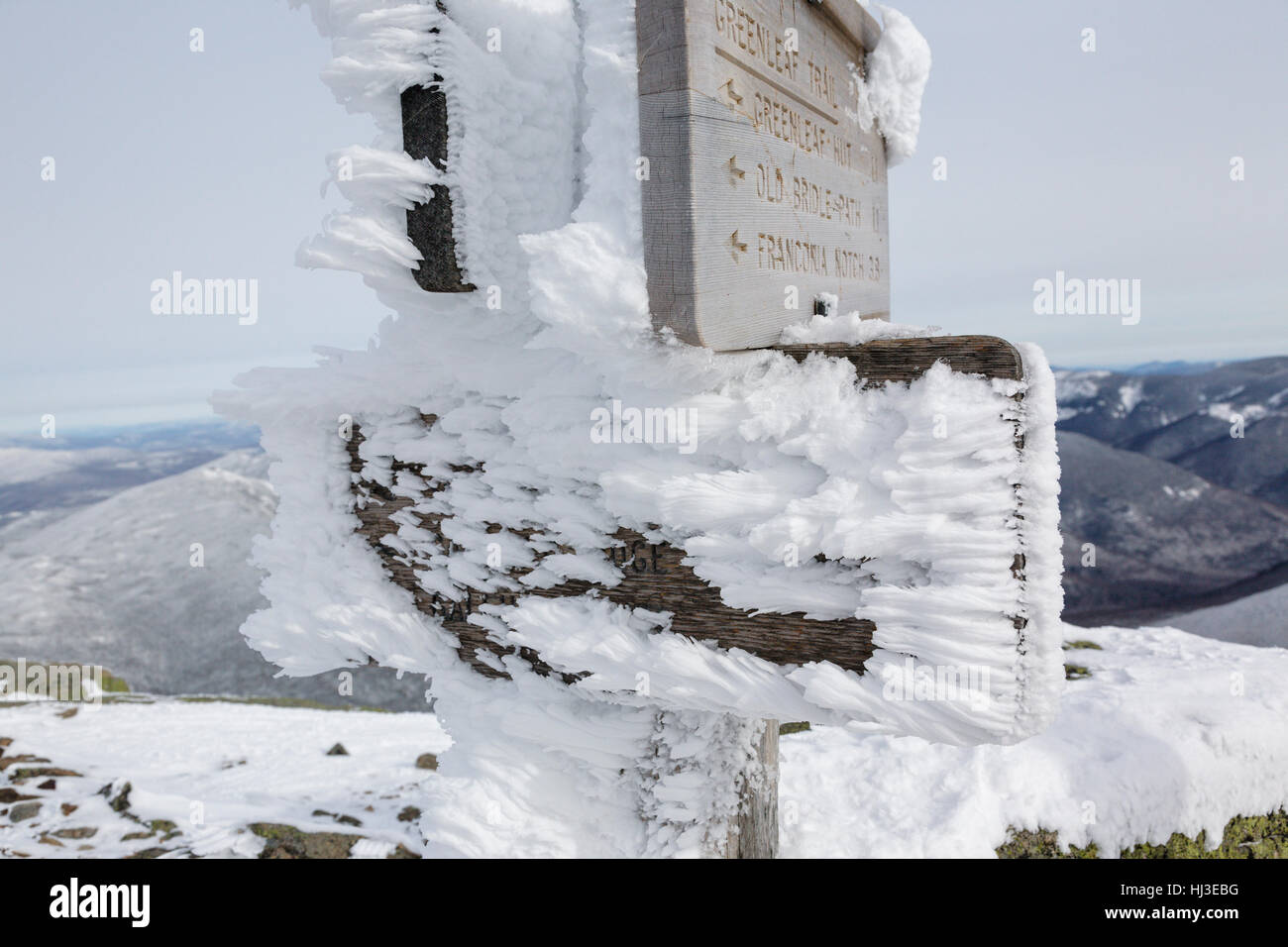Trail signs on the summit of Mount Lafayette covered in snow during the